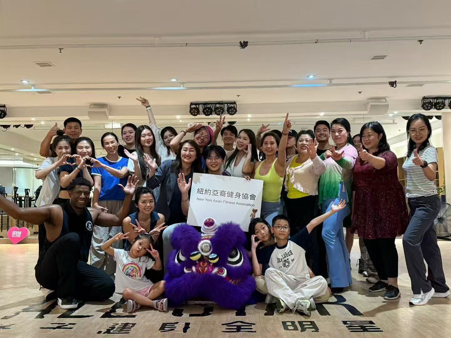 纽约亚裔健身协会会员在法拉盛活动现场手持协会横幅合影